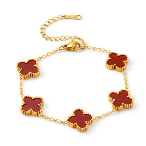 Gold bracelet with red clover-shaped charms on a white background